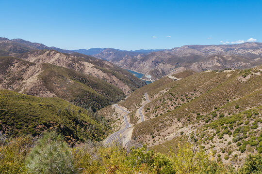 Scenic view of mountainous landscape with winding road and distant lake