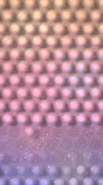 Bubble wrap popping wave seamless loop, pastel pink plastic packaging texture, vertical 4K background