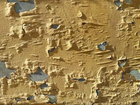Old concrete house wall with peeling paint