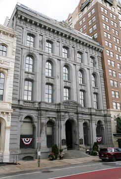 Philadelphia, Pennsylvania, U.S.A - Jul 10, 2026 - The historic stone Philadelphia Bank building with arched windows, columns, bunting, and formal entrance
