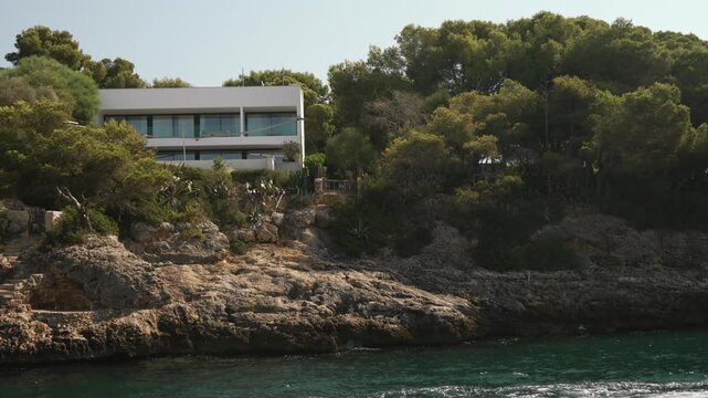 Boat cruise along the Mallorca coastline, moored yacht in a sheltered bay