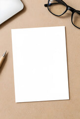 Fototapeta premium Blank white paper mockup on a brown desk with office supplies, copy space for text or design, top view flat lay