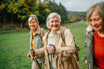 Group of mature female friends enjoying countryside walk. © Halfpoint