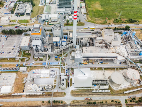 Aerial view of the Mondi SCP factory complex featuring a tall red and white chimney, industrial buildings, storage tanks, and surrounding infrastructure in Ruzomberok, Zilinsky kraj, Slovakia.