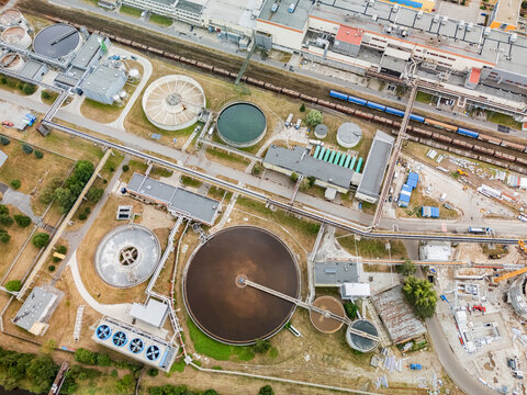 Aerial view of the Mondi SCP factory featuring large circular sedimentation tanks, industrial infrastructure, and railway tracks in Ruzomberok, Zilinsky kraj, Slovakia.