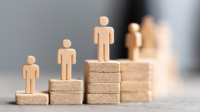 Wooden figures representing career growth and business hierarchy with leadership