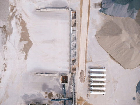 Aerial view of a concrete production facility with storage silos and a row of liquefied petroleum gas tanks in Latvia.