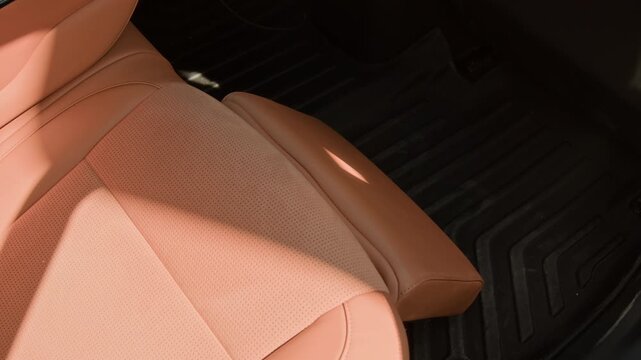 Luxury car seat extending automatic leg rest support, high angle shot. Perfect for automotive marketing, luxury vehicle reviews, and smart car technology promotions