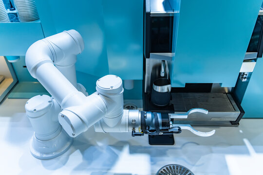 automatic robot arm preparing coffee with coffee machine