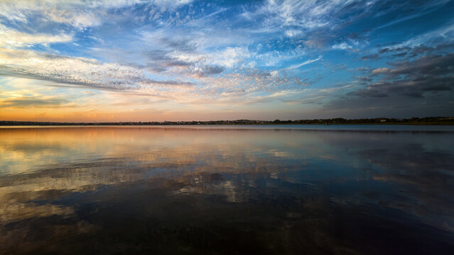 Sunset sky reflection on calm lake