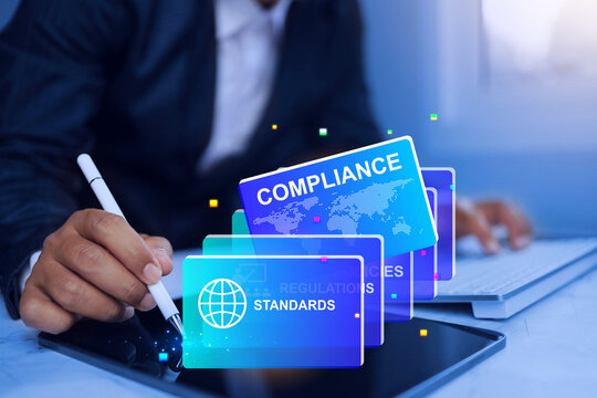compliance concept with businessman searching electronic documents for compiled a regulation and standards requirement