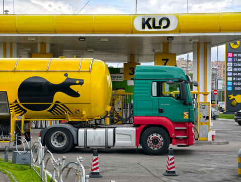 Petroleum tanker vehicle in yellow at KLO gas station for fuel delivery logistics