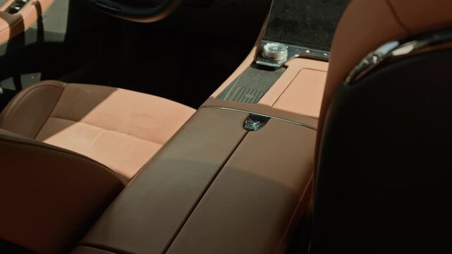 Luxury car interior showcasing premium brown leather seats and modern center console. Clip is ideal for automotive marketing, dealership promotions, and luxury lifestyle commercials