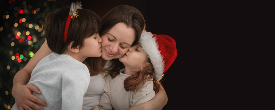 Portrait of mother son daughter celebrate christmas together banner copy space on dark background