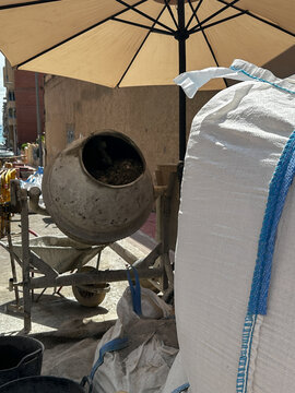 Portable cement mixer with dry building materials.