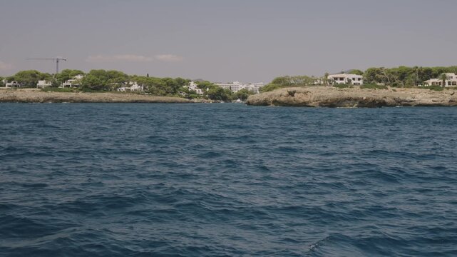 Boat cruise along the Mallorca coastline, coastal cliffs from the water