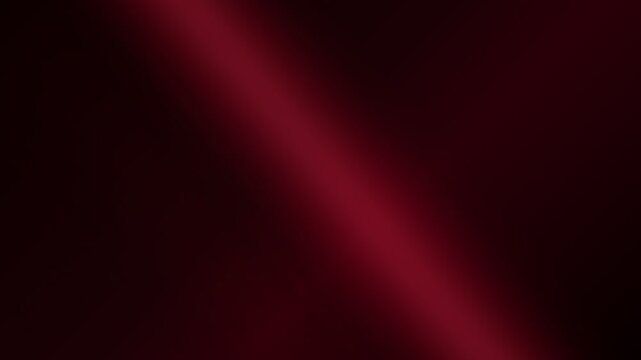 Abstract background featuring a soft diagonal beam of deep crimson red light