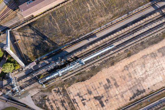 Aerial view of the decommissioned Kraftwerk Heyden in Lahde, featuring an empty coal storage yard, industrial infrastructure, and concrete surfaces in Petershagen, North Rhine-Westphalia, Germany.