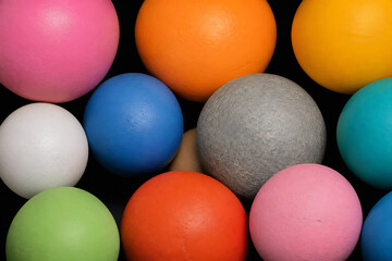 Naklejka premium A collection of colorful, textured spheres is displayed against a black background.