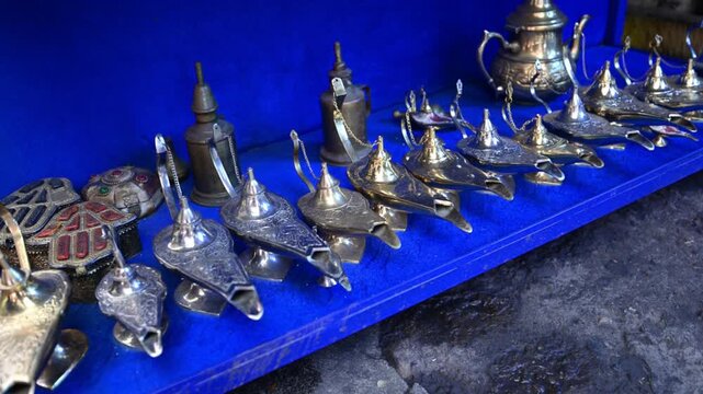 Marrakech, morocco. August 8, 2026. Silver and brass traditional moroccan lamps and teapots for sale in a stall at the medina souk in marrakech, north africa