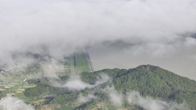 Aerial drone view of Don Duong Lake from Dran Pass, surrounded by green mountains and valleys in D'Ran, Lam Dong Province, Vietnam.