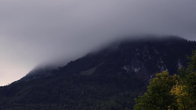 Timelapse of Fog Dissipating from Rocky Mountain Peak revealing Blue Sky