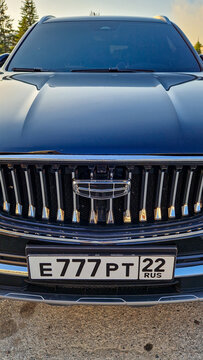 Front view of a Geely electric SUV with the Geely emblem and a Russian license plate (Region 22) in Barnaul; a modern Chinese crossover, Altai Region, Siberia, Russia 25.05.25