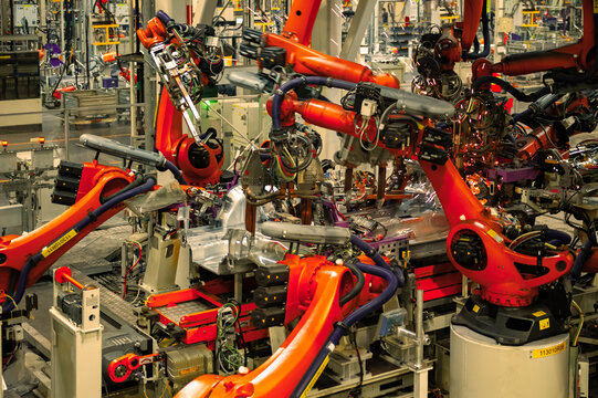 Industrial Robots Welding Car Body in Automotive Manufacturing Factory

