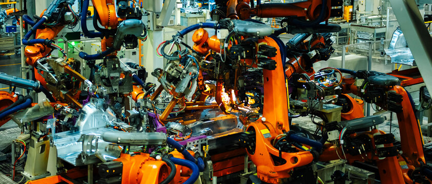 Industrial Robots Welding Car Body in Automotive Manufacturing Factory

