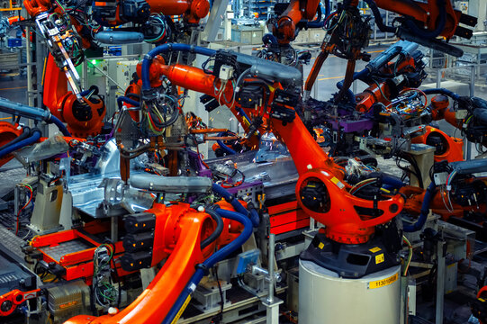 Industrial Robots Welding Car Body in Automotive Manufacturing Factory

