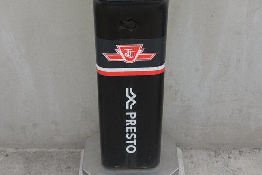 TTC corporate logo and Metrolinx Presto logo on a platform-mounted PRESTO reader
