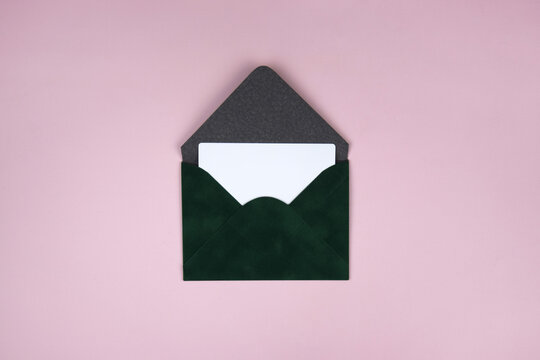 Gift voucher in a green envelope on a light background