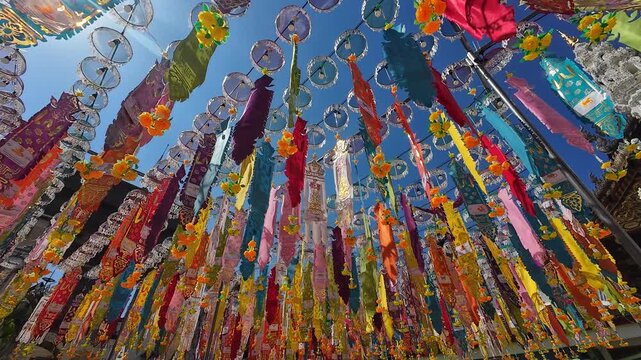 Tung or traditional buddhish flags in the Yee Peng Festival decorate around Lumphun downtown, Thailand.