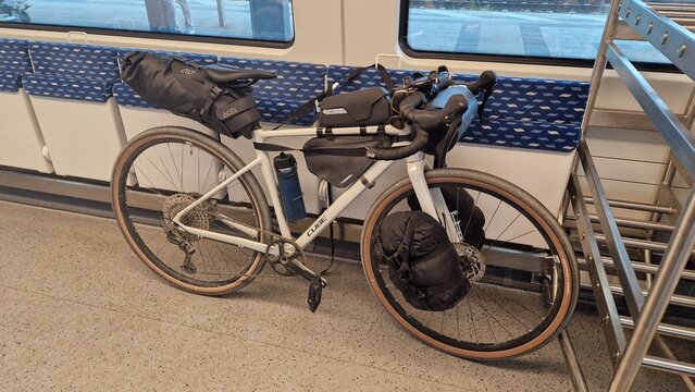 Cube gravel bike bikepacking bags in the bicycle compartment of a train; sustainable travel to a cycling trip and micro-adventure local public transport; DB regional train, Germany W&uuml;rzburg 15.05.26