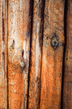 Weathered wooden wall with rough natural grain and warm earthy tones