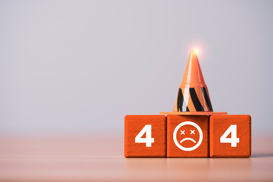 404 error concept with orange traffic cone and sad face on wooden blocks symbolizing broken links, missing web pages, website failure, technical problems, maintenance and online access errors.