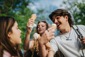 Naklejka premium A teenager enjoys an ice cream cone outdoors with friends. A small group of friends laugh and share cones in a park setting.