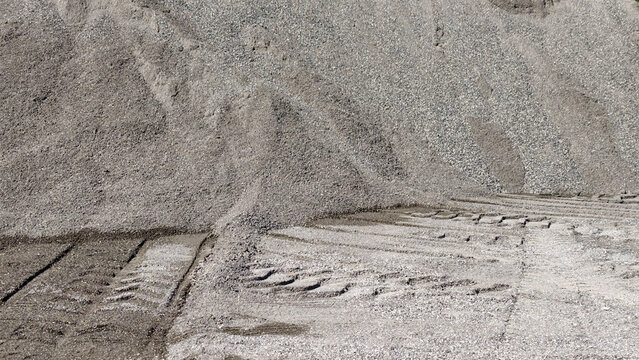 Gravel and sand building materials creating a textured background, showing the raw resources used in construction, road building, and civil engineering projects