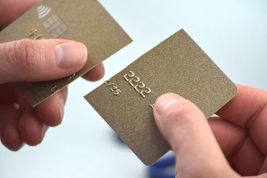 The woman is cutting her credit card in half because it expired