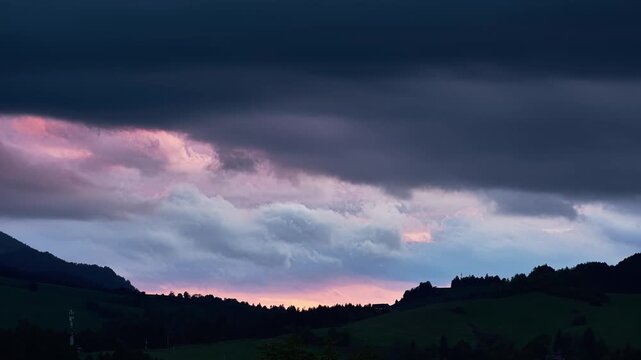 Dramatic Sunset Sky over Dark Mountain Hills and Rolling Fields