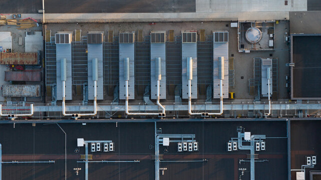 Aerial view of industrial rooftop ventilation systems and HVAC units on a large commercial building in Bracknell, England, United Kingdom.
