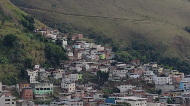 Dense Hillside Housing Cluster Beneath Overcast Mountain Sky