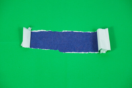 A blue paper layer revealed beneath a torn green paper layer. A torn paper section with space for text against a blue background. The torn green paper layer is pulled back, exposing the blue layer und