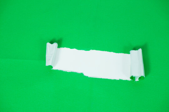 A white paper layer revealed beneath a torn green sheet. A torn paper section with a white background area for text. The torn green paper layer peels back, exposing the white layer underneath.
