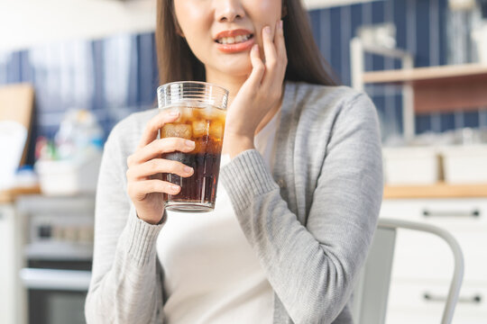 Health care asian young woman touching mouth, expression, girl suffering from toothache, decay or sensitivity cavity molar tooth or inflammation drink cold, sparkling water. Sensitive teeth people.
