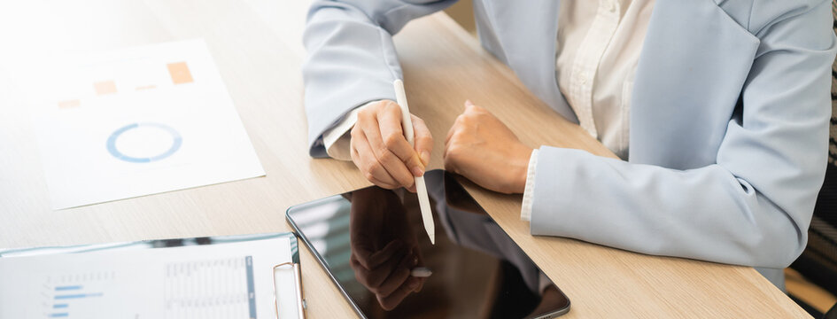 Business meeting, asian group brainstorm analysis on graph data of cost plan. financial consult planning investor asses and present to client, client and advisor review investment strategy in office.