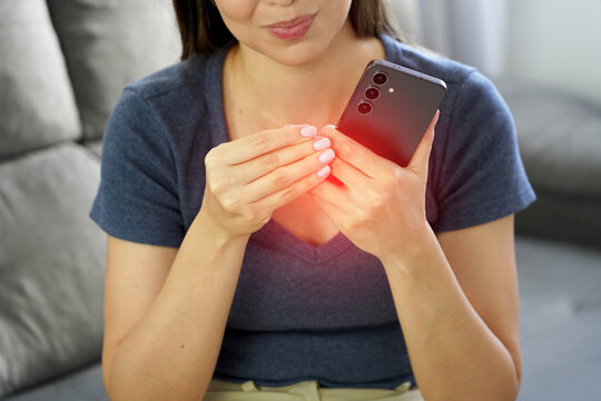 Close Up of Young Woman Suffering from Finger Pain and Smartphone Syndrome While Holding Phone at Home