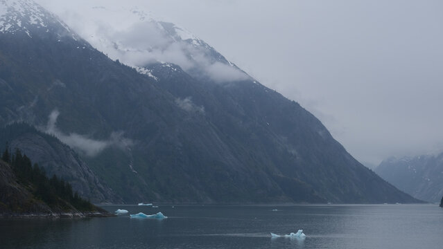 Breathtaking Alaska mountain glacier range view seen from outdoor deck of cruise ship liner sailing the Inside Passage transit with spectacular landscape wilderness scenery