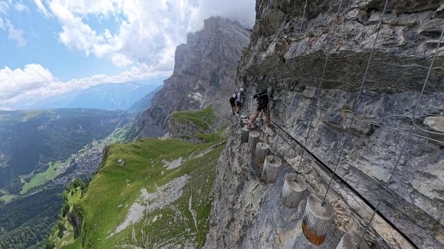 Climber Crossing the Woody Pecker Section of Gemmi Adventure Via Ferrata Above Leukerbad, Swiss Alps