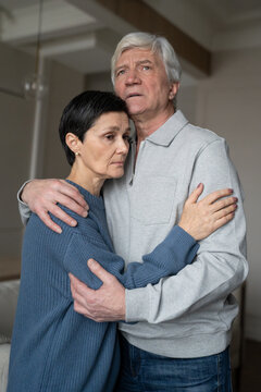 Anxious troubled senior couple embracing provide comfort lovingly. Partnership trust in crisis, love compassion, kinship warmth, retired life issues, health concerns, emotional support relationship